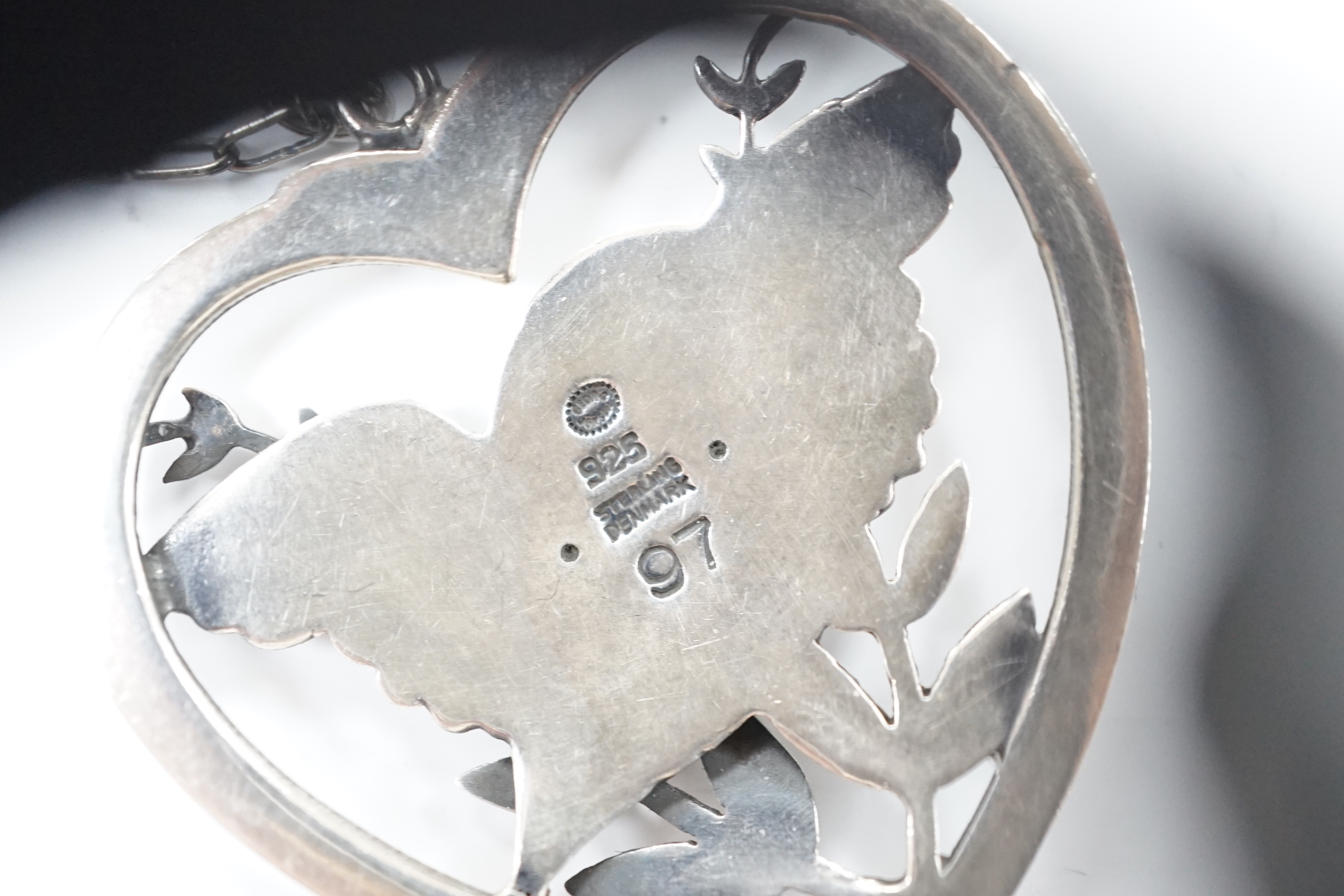 A Georg Jensen sterling heart shaped 'Robin with frond' pendant, on chain, design no. 97, width 39mm.